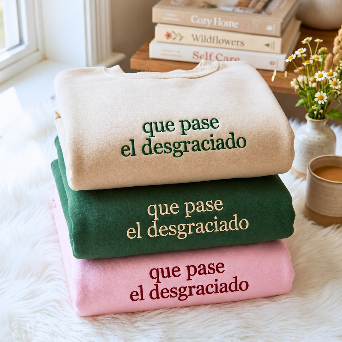 Que Pase El Desgraciado embroidered sweatshirts in white, forest green and pink