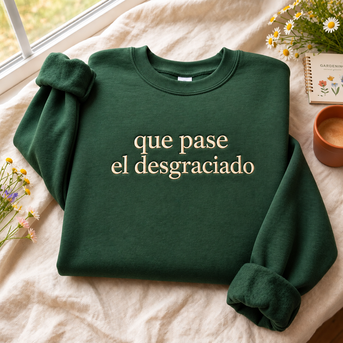 Forest green sweatshirt with cream Que Pase El Desgraciado embroidered design