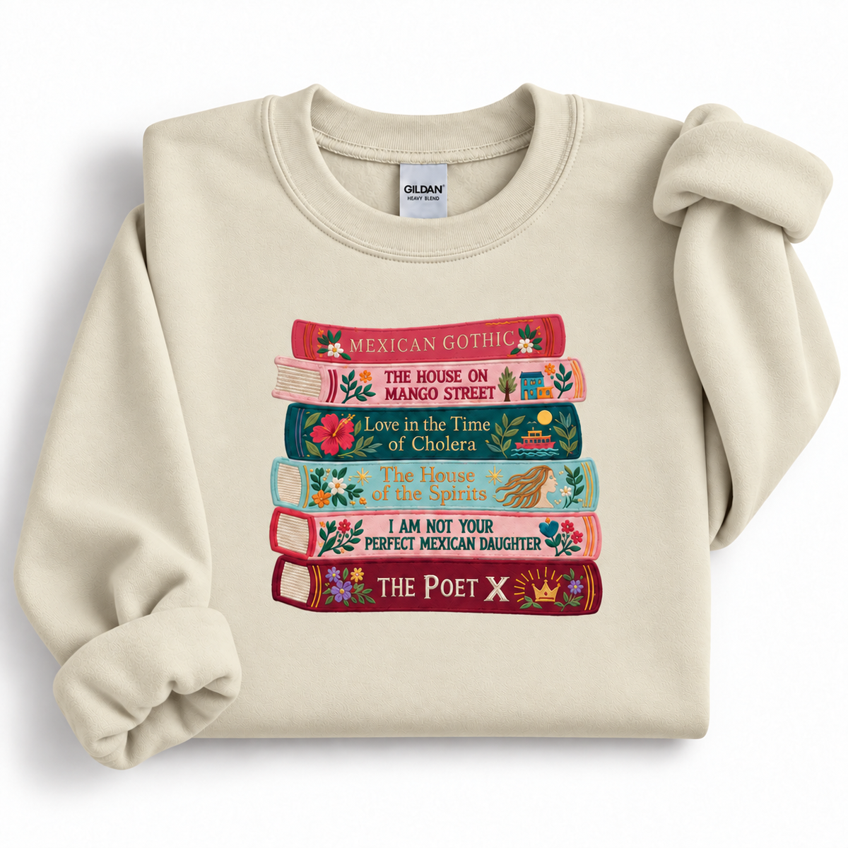 Sand Gildan 18000 crewneck sweatshirt with six colorful embroidered book spines and floral illustrations.