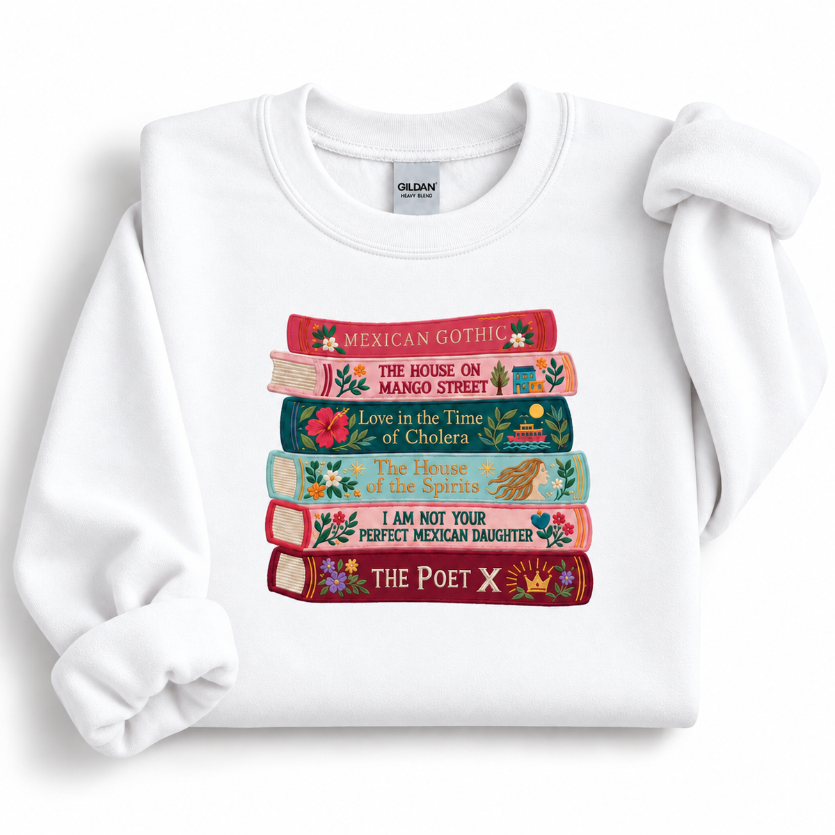 White Gildan 18000 crewneck sweatshirt featuring a colorful embroidered stack of six books by Latina and Latin American authors.